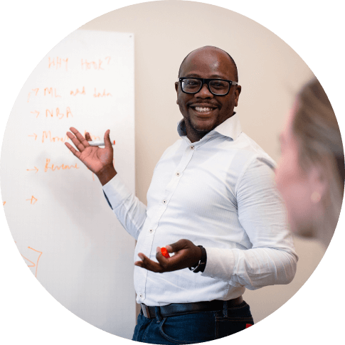 A Man pointing at a whiteboard